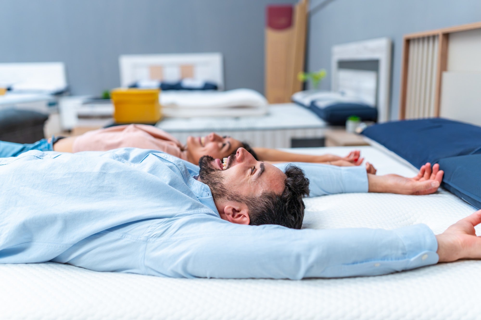Couple trying out mattresses in the showroom